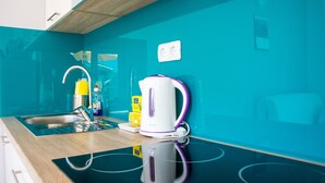 A modern kitchen with a sink, a kettle, and a lemon container. - Apartments Villa Franci (Pag)