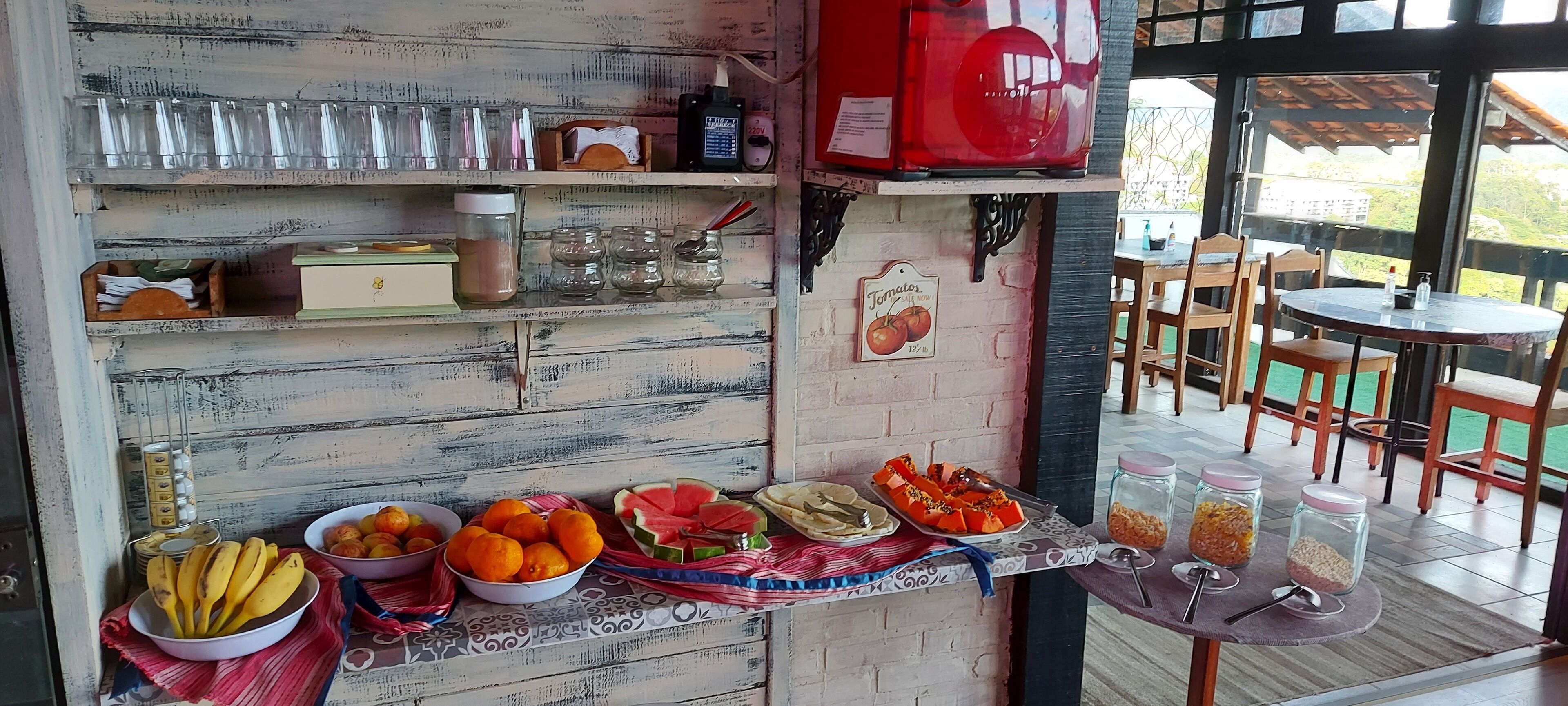 A breakfast bar with various fruits, condiments, and utensils.