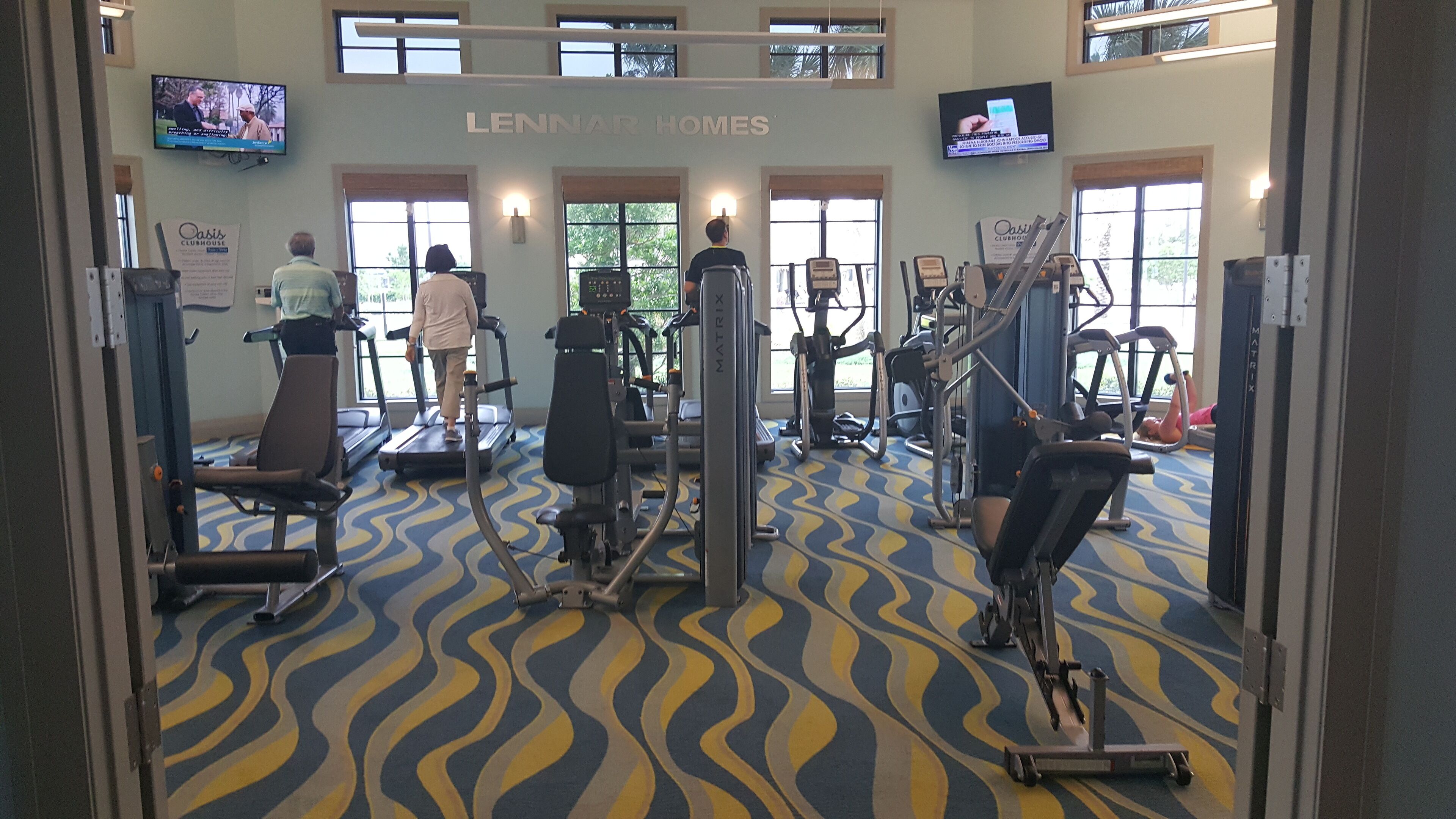 A gym with treadmills, stationary bikes, and weight machines.