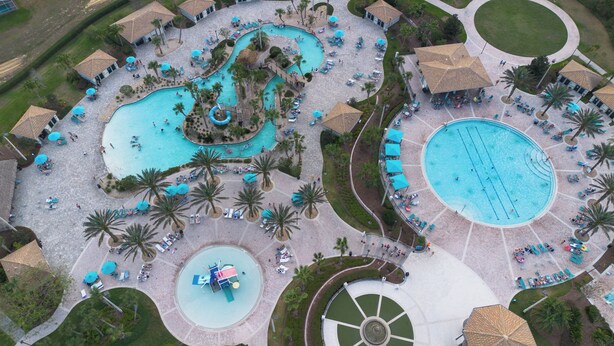 An aerial view of a resort with multiple swimming pools, palm trees, and lounge areas. - Private Pool-Upgraded Interior-Poolside Bar (Davenport)
