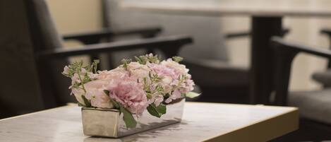 A table with a vase of flowers in a modern setting.