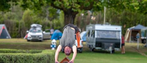 A person performing a handstand on a colorful mat.