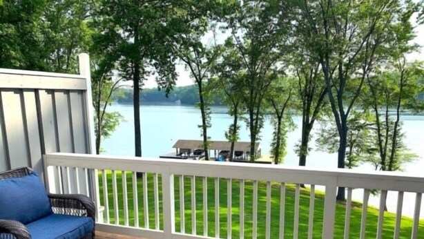 A wooden deck with wicker furniture overlooking a lake and trees. - Shorely Heaven:  WiFi, Disney+, Amazon Prime, YouTubeTV, (2) Kayaks Wide Water Lake Views (Moneta)
