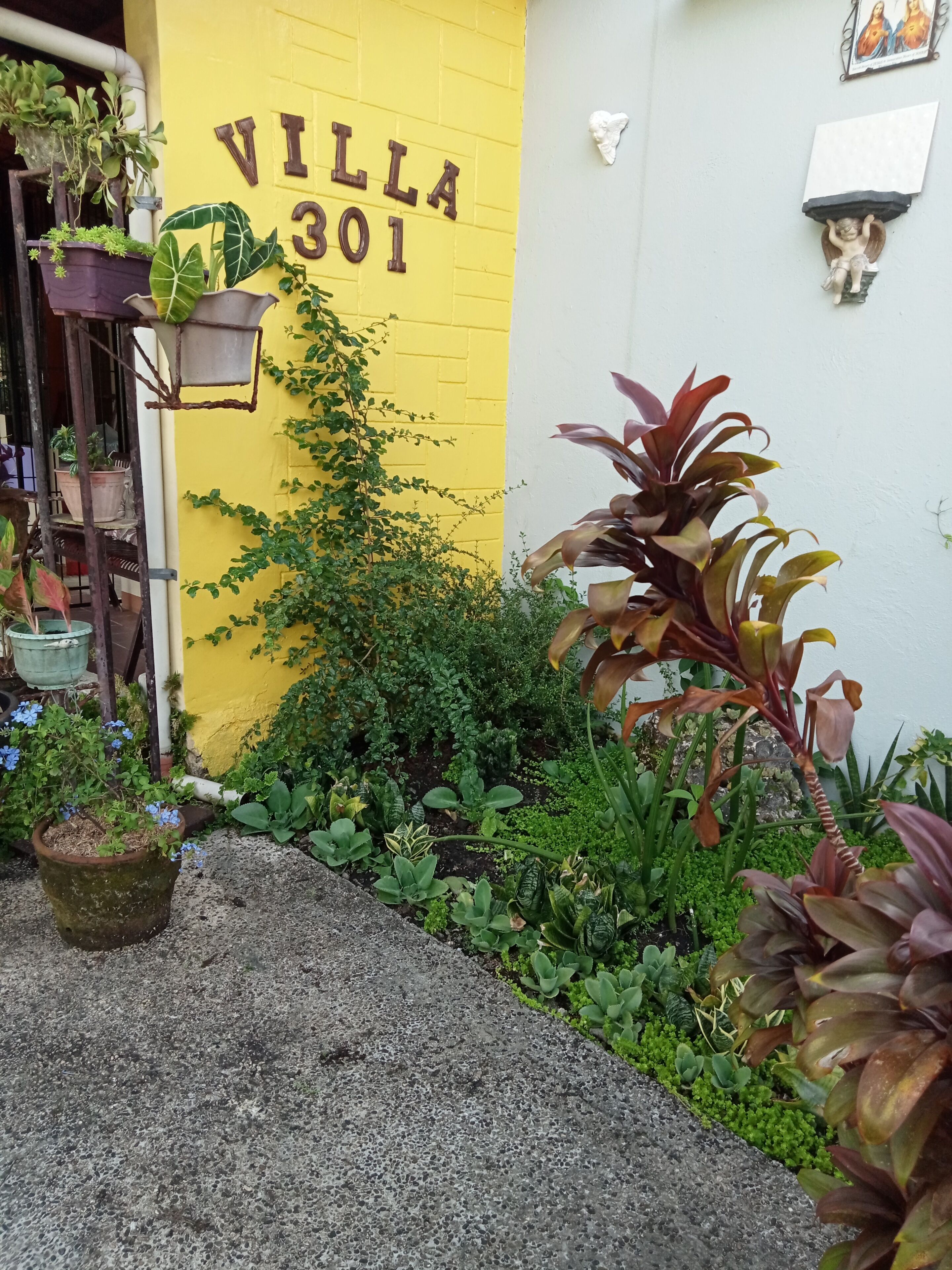A yellow building with the number 301 and the word "VILLA" on the wall.