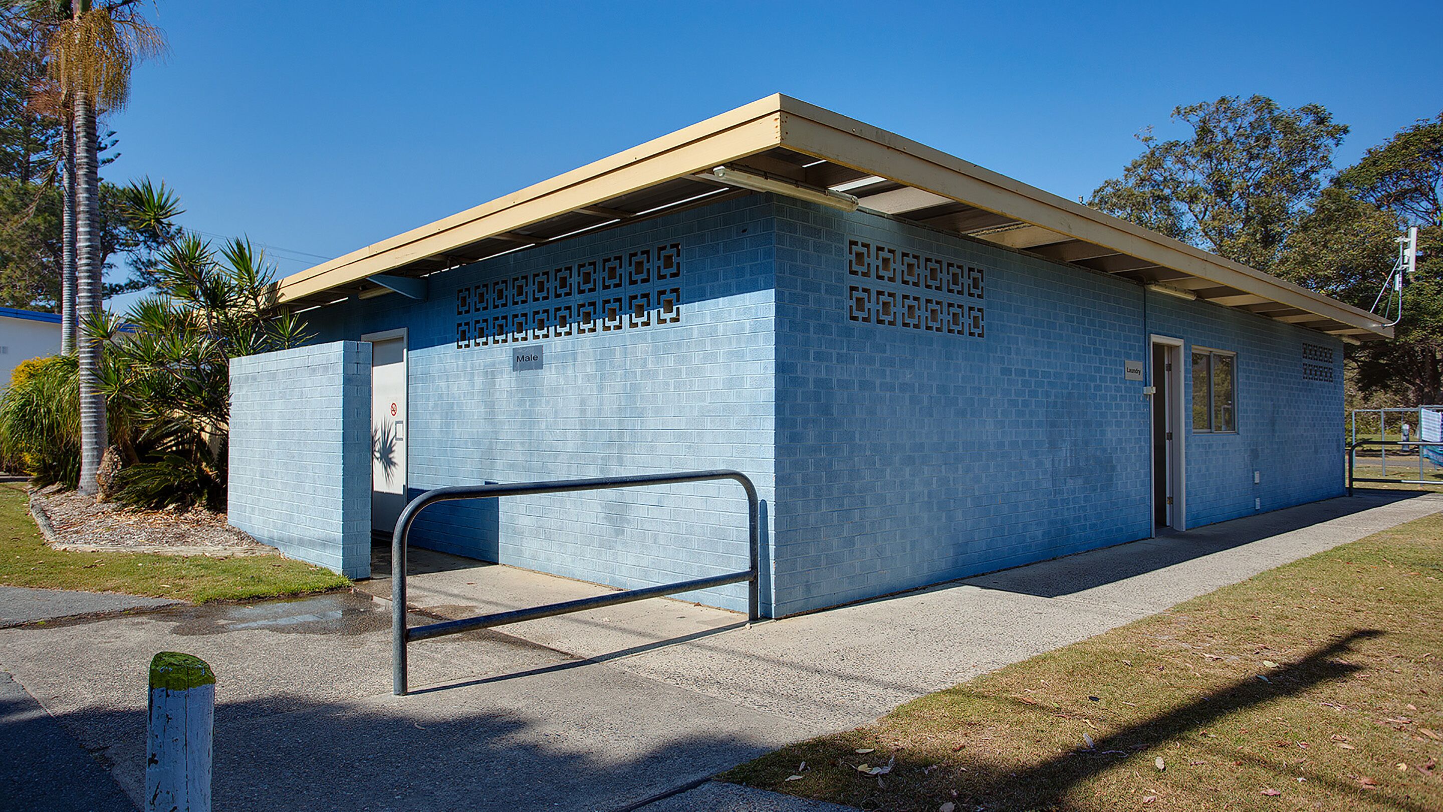 A small, single-story building with a blue exterior and a flat roof.