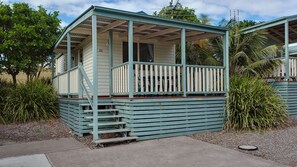 A small, single-story building with a porch and a staircase leading to the entrance. - Crescent Head Holiday Park (Crescent Head)
