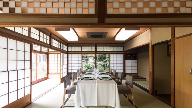 A traditional Japanese room with tatami flooring, a low table set for dining, and sliding doors. - Nanzenji sando KIKUSUI (Kyoto)