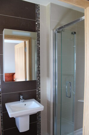 Bathtub, hair dryer, towels, toilet paper