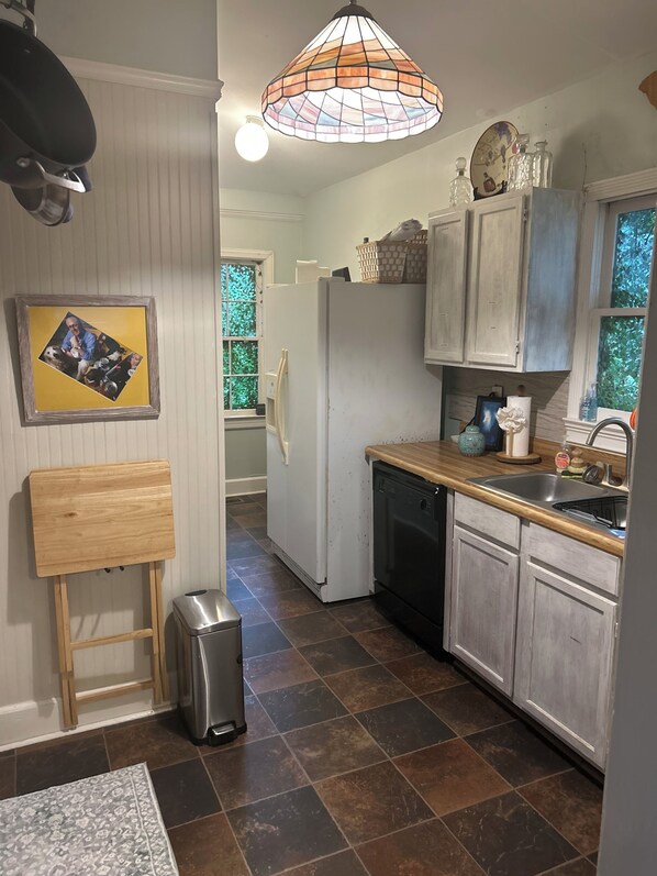 A kitchen with a refrigerator, sink, and wooden countertop. - Shandon’s Best: Bubba’s Tranquil Treehouse Permit # STR-000211-2025 (Columbia)
