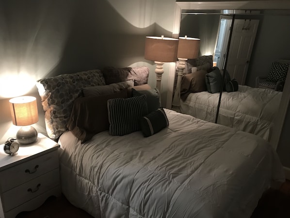 A bedroom with two beds, a nightstand with a lamp, and a mirror. - Shandon’s Best: Bubba’s Tranquil Treehouse Permit # STR-000211-2025 (Columbia)