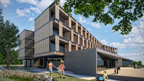 Een modern gebouw met meerdere balkons, een centrale binnenplaats en een restaurantgedeelte.
