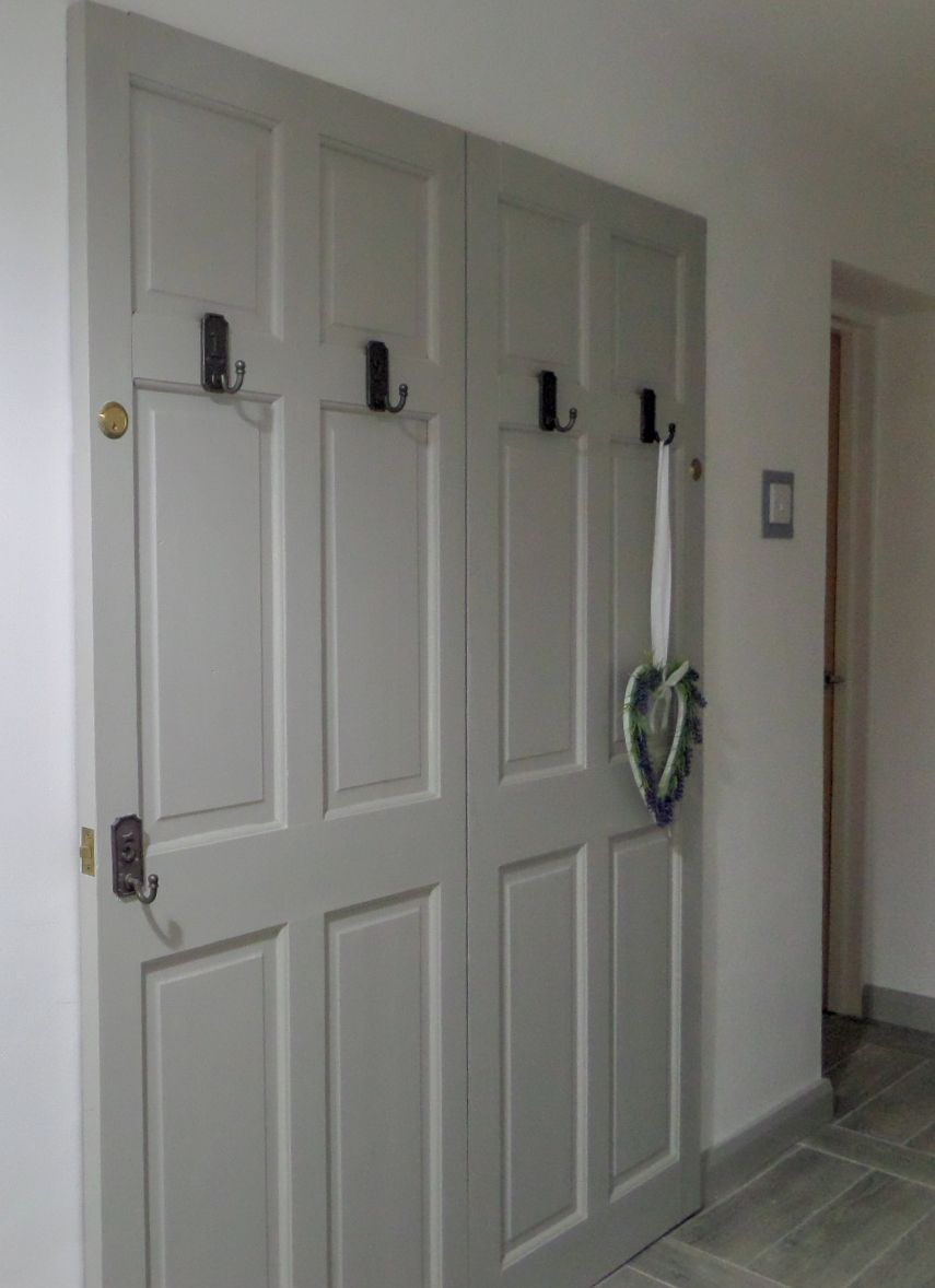 A white door with a keyhole and a doorbell.