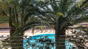 Seasonal outdoor pool, open 8:00 AM to 10:00 PM, pool umbrellas
