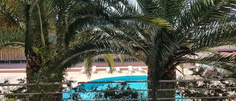 Seasonal outdoor pool, open 8:00 AM to 10:00 PM, pool umbrellas