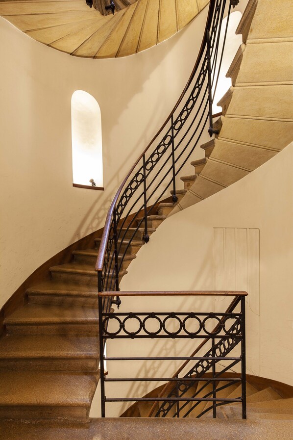 A spiral staircase with a metal railing and a small window at the top. - San Marco Superior Apartments by Wonderful Italy (Venice)