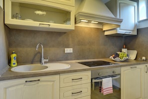 Apartment | Private kitchen | Fridge, stovetop, coffee/tea maker