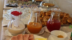 A breakfast buffet with various food items and beverages. - Miramare Scilla GYH Luxury (Scilla)