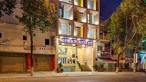 A multi-story hotel with a prominent sign at the top. - Merry Hotel (Da Nang)