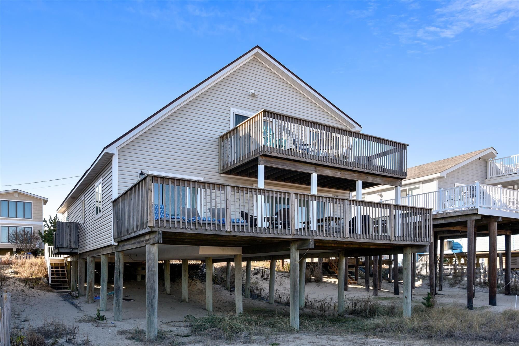 FREE DAILY ACTIVITIES!  This classic ocean front family vacation beach house sits right on the beach offering incredible ocean views and gorgeous sunrises!