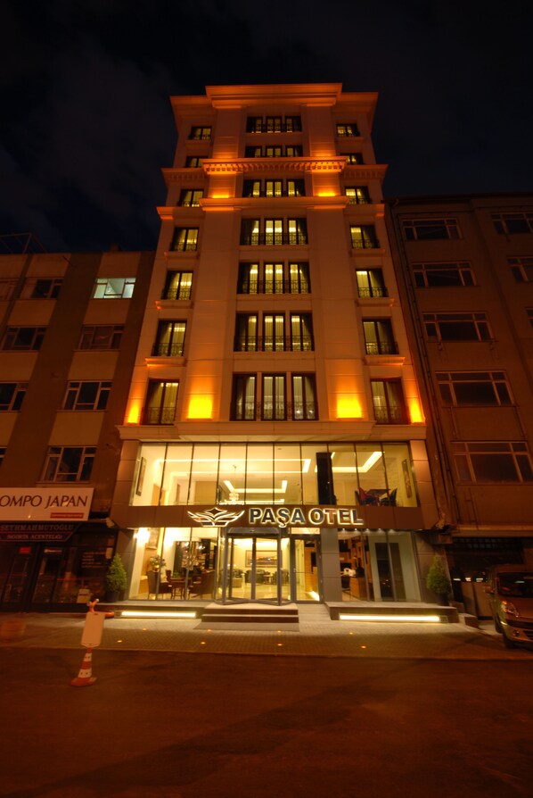 A multi-story hotel with illuminated windows and a prominent entrance.