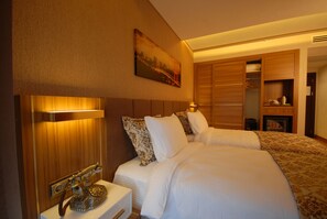 A hotel room with a bed, bedside table, and a telephone.