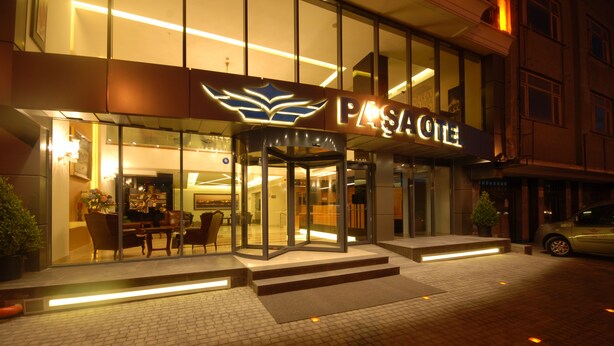A hotel entrance with a glass facade, a revolving door, and a sign that reads "PASACOTE". - Imamoglu Pasa Hotel - Boutique Class (Kocasinan)