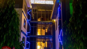 The Francis Hotel with a prominent neon sign, a glass entrance, and a 'No Parking' sign in front. - Francis Hotel (Abuja)