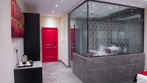 A modern hotel lobby with a red door, a glass partition, and a seating area with a view. - Francis Hotel (Abuja)