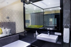 A modern bathroom with two sinks, a large mirror, and patterned wallpaper. - Francis Hotel (Abuja)