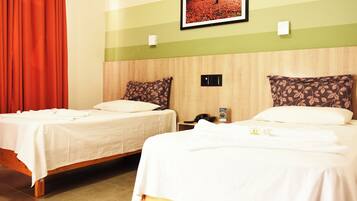 Minibar, escritorio, cortinas blackout y tabla de planchar con plancha