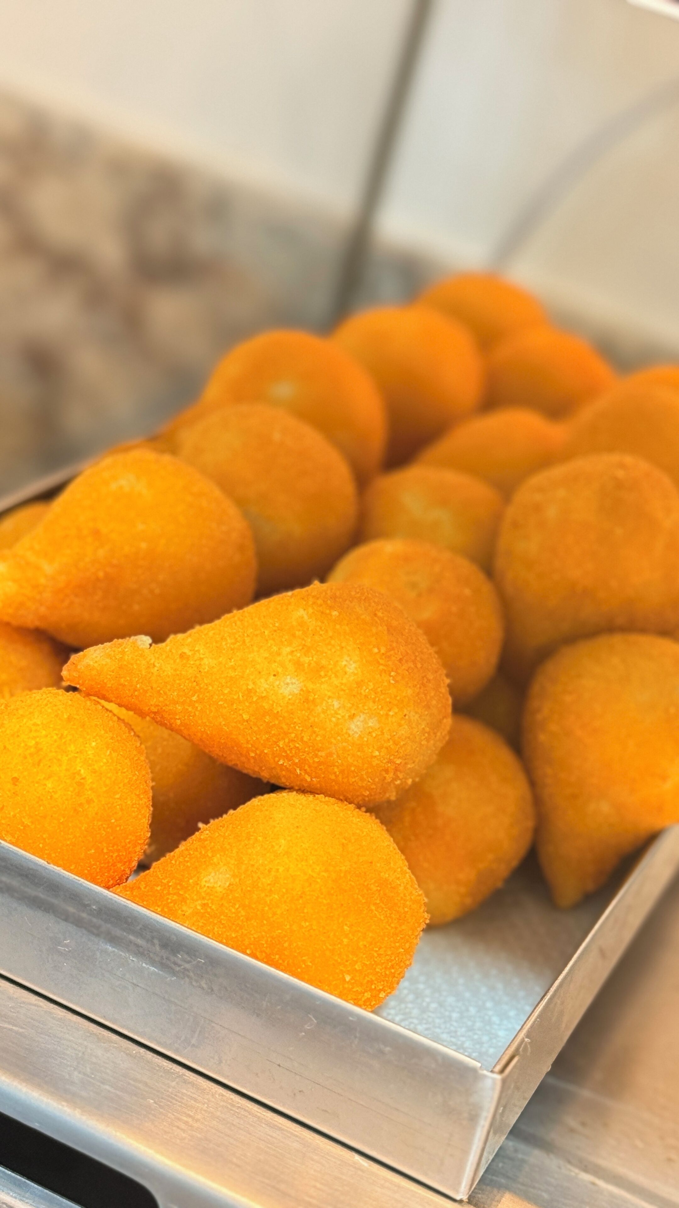 A tray of golden-brown fried food items.