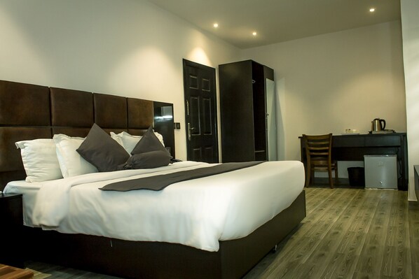 A modern hotel room with a large bed, a desk, and a chair. - Atlantic Hotel and Spa (Lagos)