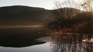 A mountain reflected in a calm lake with clear skies. - Lyndhurst Guest House (Keswick)