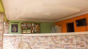 Une pièce avec un mur recouvert de carreaux, un plafond doté d’un éclairage encastré et une fenêtre donnant sur l’extérieur.