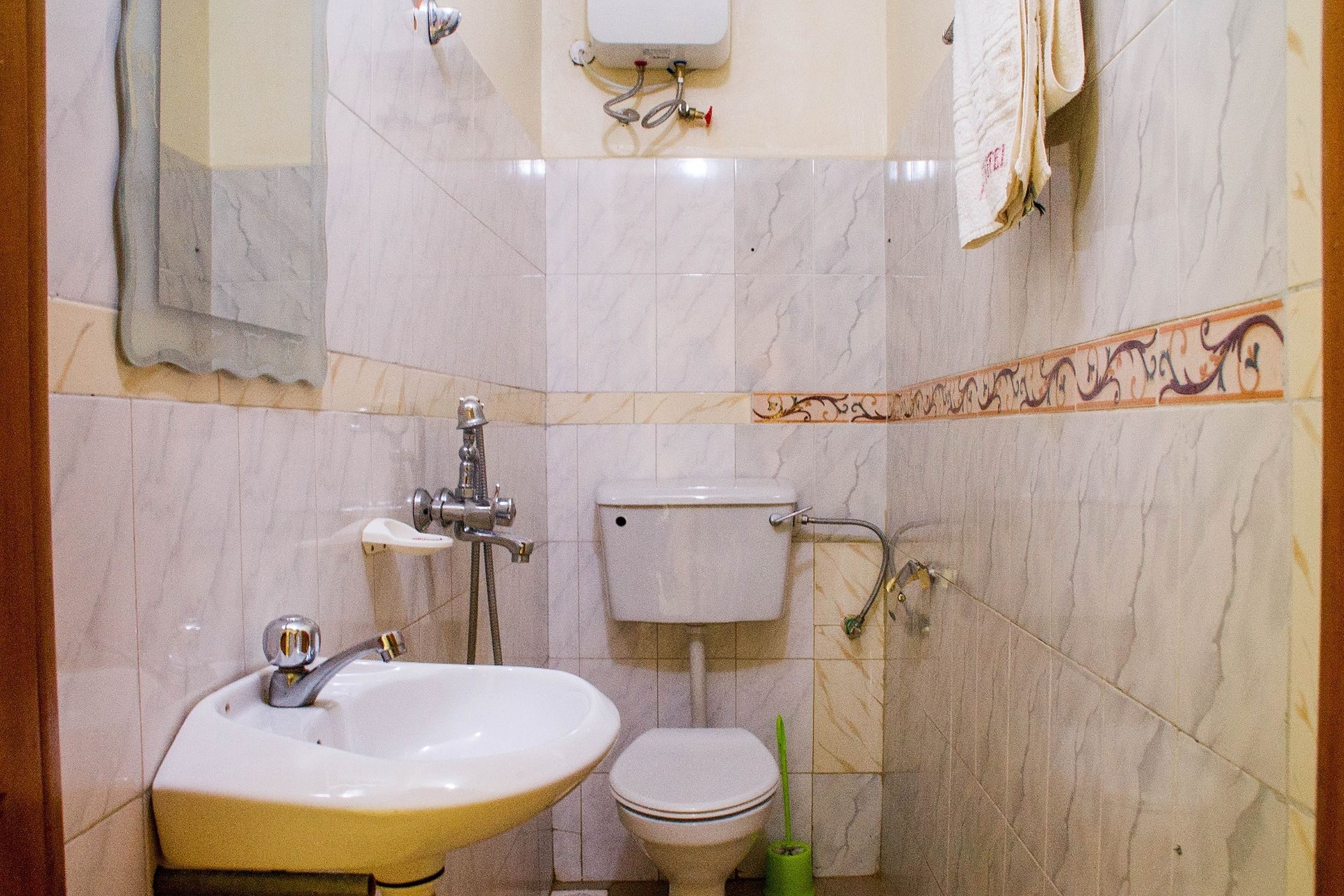 A bathroom with a sink, toilet, and shower.