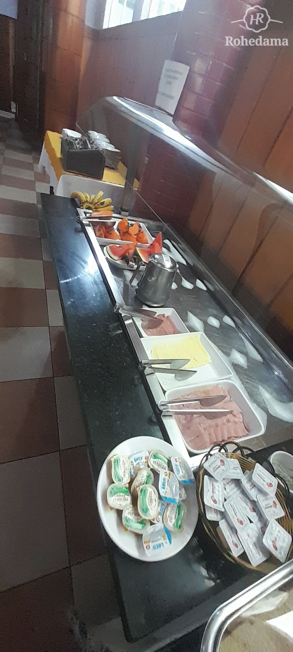 A buffet with various food items including fruits, vegetables, and dairy products.