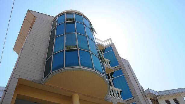 A modern building with a curved facade, multiple balconies, and large windows. - Grand Guest House (Addis Ababa)