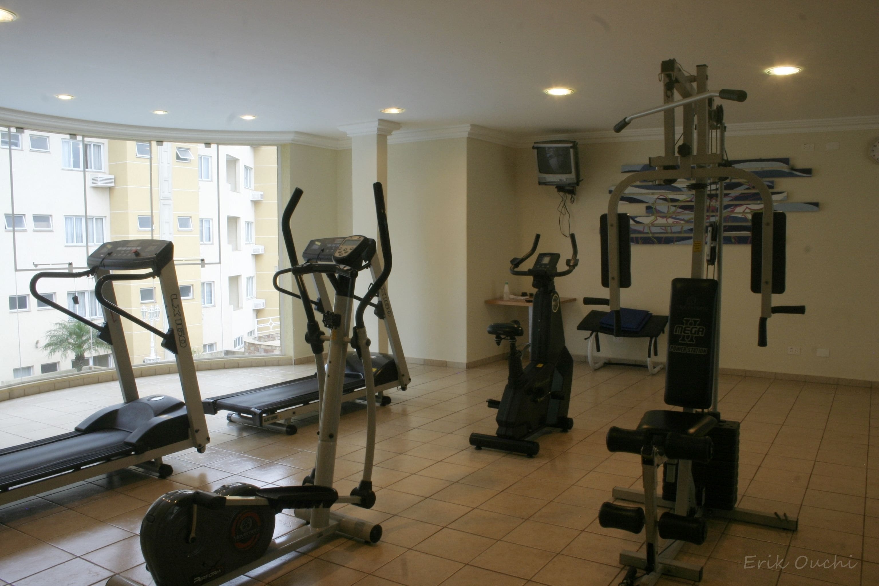 A gym with treadmills, elliptical machines, and weight equipment.