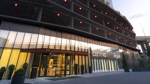 A modern building with a glass facade, a lower level with a covered area, and a sign reading "CENTRO Arjaan". - Westside Residences By Rotana (Istanbul)