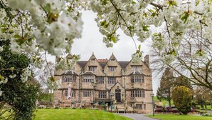 A large stone building with multiple windows and a central entrance. - Weston Hall (Stafford)
