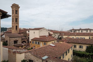 A historic town with a prominent tower, terracotta-roofed buildings, and narrow streets.