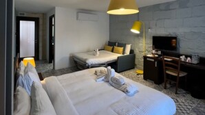 A hotel room with a large bed, a desk, a chair, and a television. - MyTravel House (Rabat)