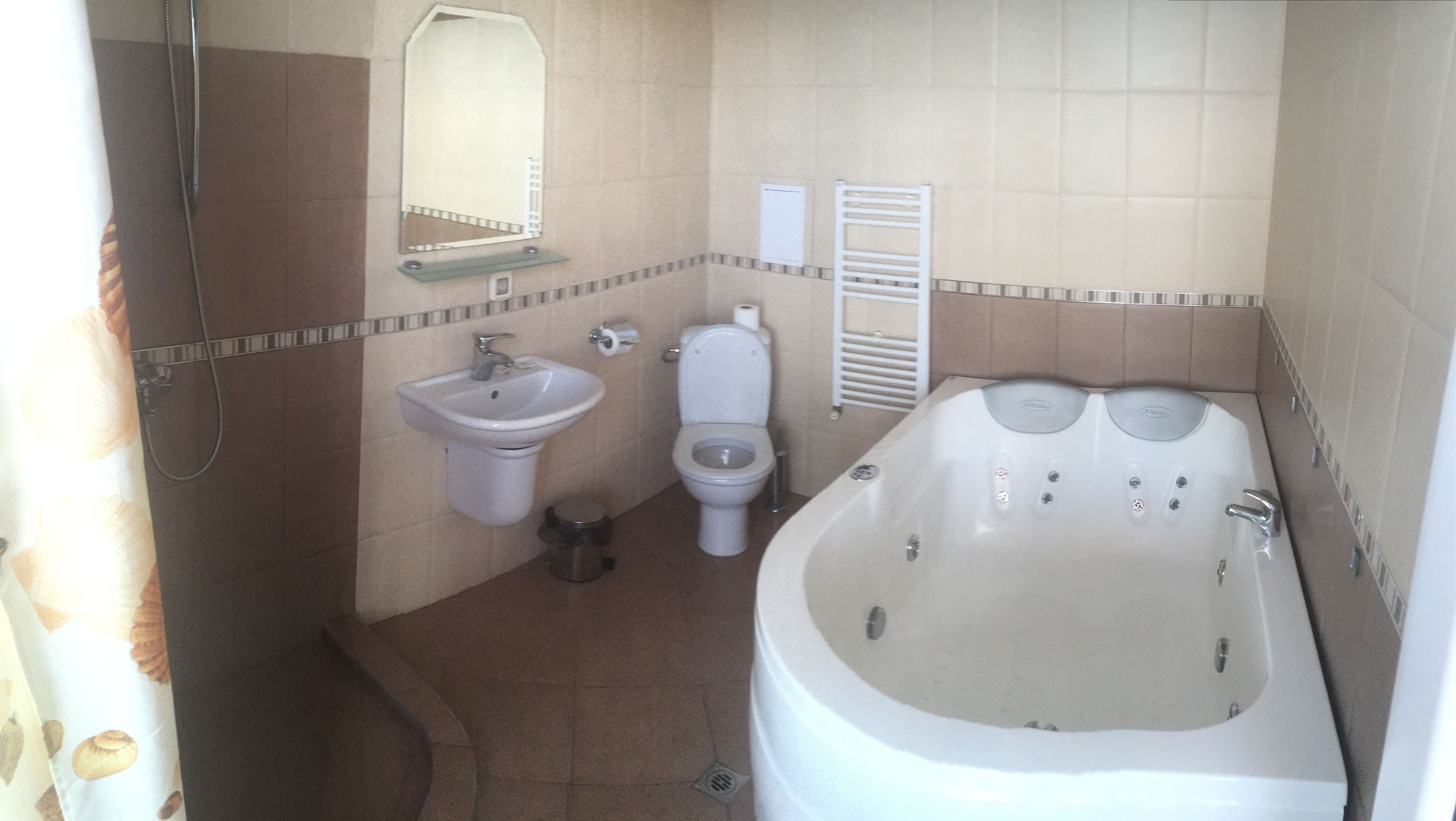 A bathroom with a sink, toilet, and bathtub.