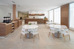 A modern kitchen with a central island, bar area, and seating for six. - Element by Marriott Edmonton West (Edmonton)