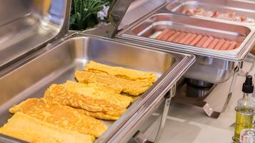 A buffet with omelettes and hot dogs.
