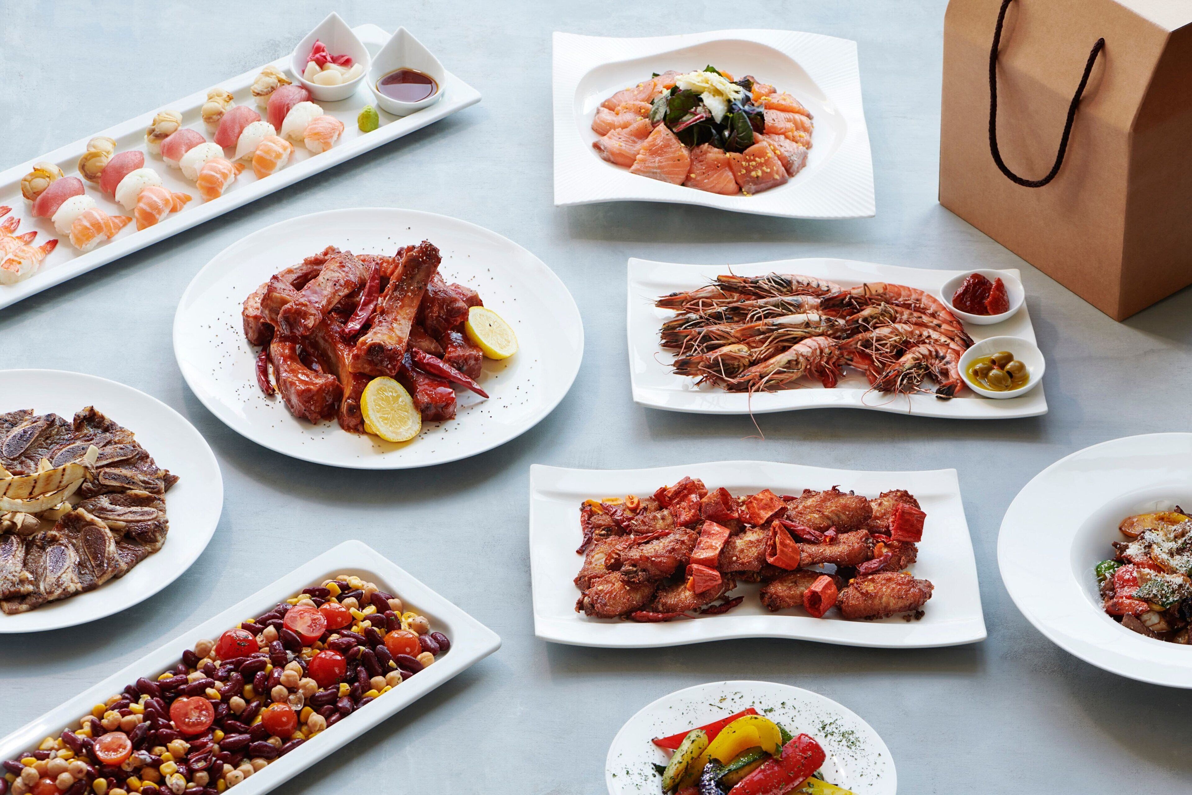 A variety of dishes on a table, including seafood, meats, and vegetables.