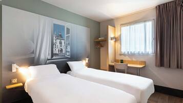 A hotel room with two beds, a desk, a chair, a painting on the wall, and a window with curtains.