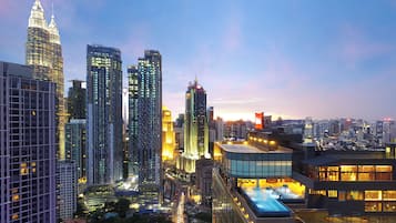 A cityscape with high-rise buildings, including a prominent skyscraper with a unique design.