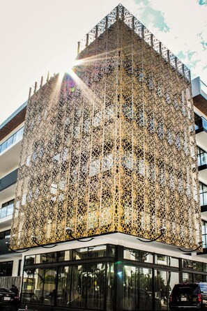 A modern building with a distinctive geometric facade and large windows. - IT Boutique Hotel & Restaurant (Playa del Carmen)