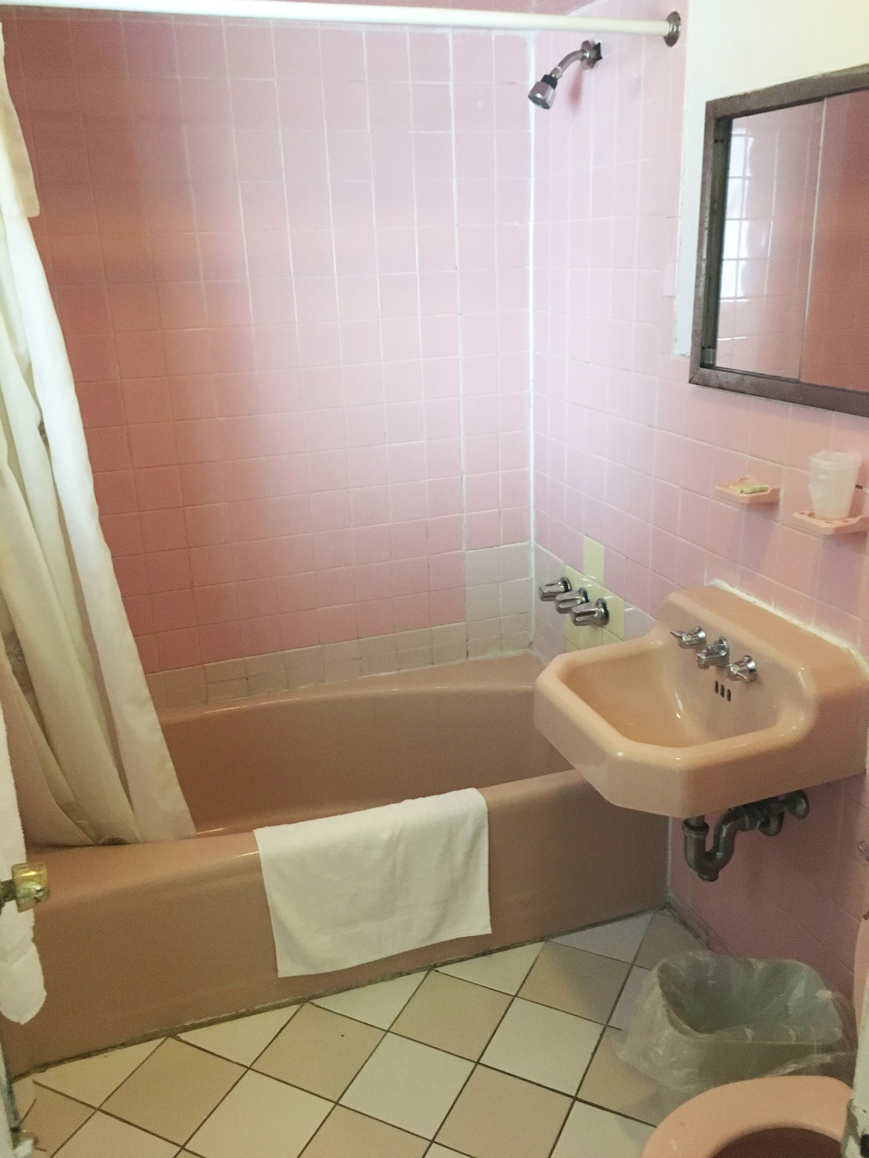 A bathroom with a bathtub, sink, and toilet.